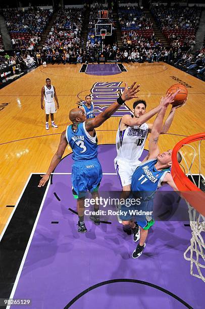 Omri Casspi of the Sacramento Kings shoots against Damien Wilkins and Sasha Pavlovic of the Minnesota Timberwolves during the game on March 14, 2010...