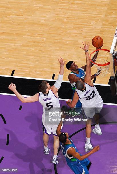 Jonny Flynn of the Minnesota Timberwolves takes the ball to the basket against Francisco Garcia and Andres Nocioni of the Sacramento Kings during the...
