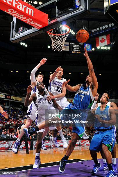 Ramon Sessions of the Minnesota Timberwolves lays up a shot against Tyreke Evans, Francisco Garcia and Andres Nocioni of the Sacramento Kings during...