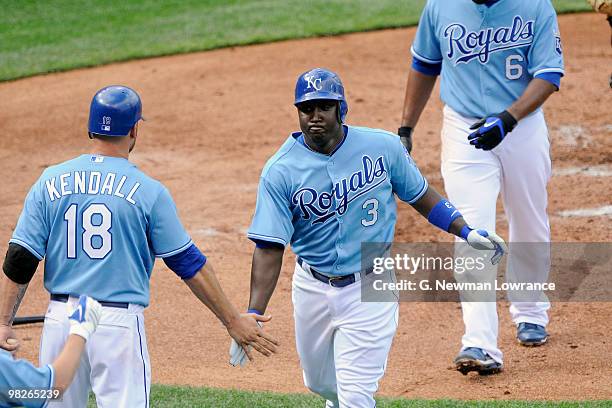Yuniesky Betancourt of the Kansas City Royals is greeted by Jason Kendall after hitting a 2-run home run against the Detroit Tigers during the season...