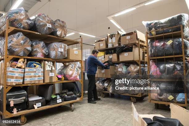 Member of staff checks the items due to be auctioned at an auction house in Berlin, Germany, 26 Janaury 2018. Lost property from the Zentrales...