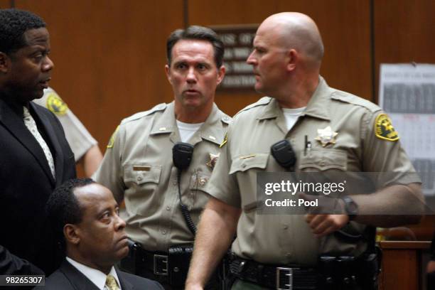 Dr. Conrad Murray sits near bailiffs as he appears at Los Angeles Superior Court on April 5, 2010 in Los Angeles, California. Murray is charged with...