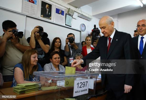 Turkish Nationalist Movement Party's Leader Devlet Bahceli casts his ballot at a polling station during the parliamentary and presidential elections,...