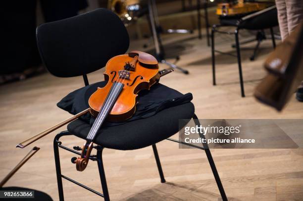 Violin lays on a stool during a rehearsal break of the symphonic orchestra of Bad Reichenhall at the concert hall of the Philharmonic Orchestra Bad...