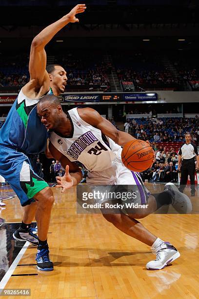 Carl Landry of the Sacramento Kings moves the ball against Ryan Hollins of the Minnesota Timberwolves during the game on March 14, 2010 at ARCO Arena...