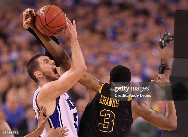 Brian Zoubek of the Duke Blue Devils with the ball against Devin Ebanks of the West Virginia Mountaineers during the National Semifinal game of the...