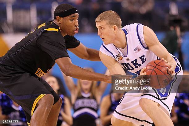 Mason Plumlee of the Duke Blue Devils with the ball against Kevin Jones of the West Virginia Mountaineers during the National Semifinal game of the...