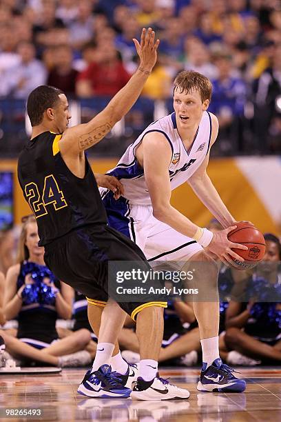 Kyle Singler of the Duke Blue Devils with the ball against Joe Mazzulla of the West Virginia Mountaineers during the National Semifinal game of the...