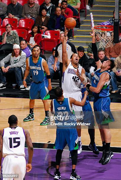 Sean May of the Sacramento Kings shoots against Oleksiy Pecherov and Corey Brewer of the Minnesota Timberwolves during the game on March 14, 2010 at...