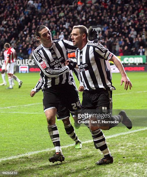 Kevin Nolan of Newcastle United celebrates with Andy Carroll after scoring Newcastle's second goal during the Coca Cola Championship match between...