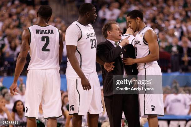 Head coach Tom Izzo of the Michigan State Spartans talks with Chris Allen from the sideline while taking on the Butler Bulldogs during the National...