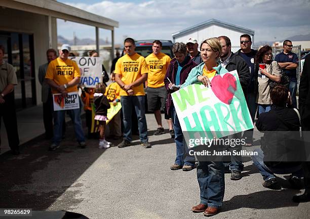 Kristen Fisher holds a sign as she stands with Pahrump firefighters while U.S. Senate Majority Leader Harry Reid speaks in front of the local...
