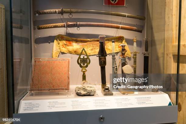 Display cabinet of Second World war trophies from Germany and Japan, REME museum, MOD Lyneham, Wiltshire, England, UK.