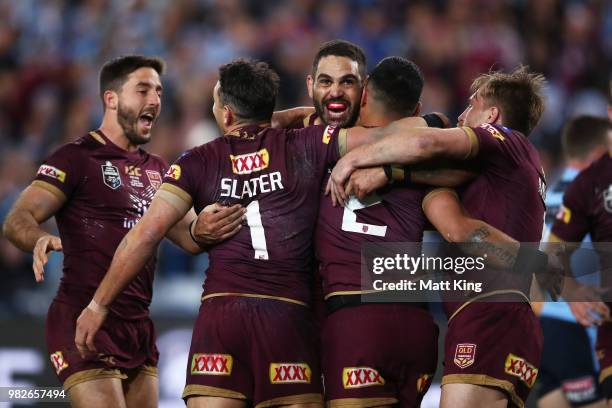 Valentine Holmes of the Maroons celebrates with Greg Inglis and team mates after scoring a try during game two of the State of Origin series between...