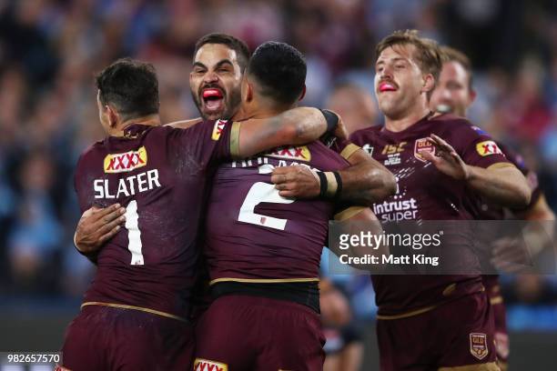 Valentine Holmes of the Maroons celebrates with Greg Inglis and team mates after scoring a try during game two of the State of Origin series between...