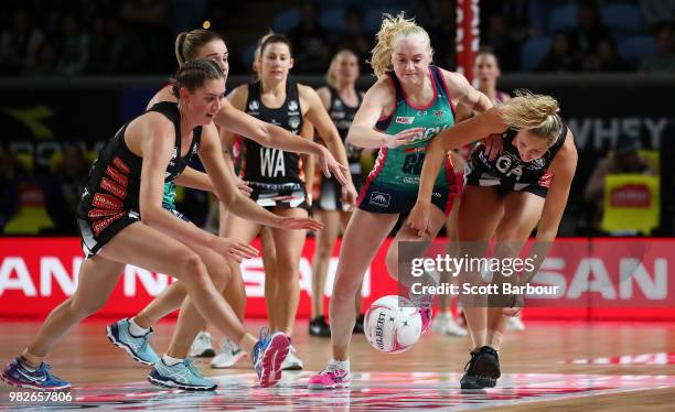 Matilda Garrett and Erin Bell of the Magpies and Joanna Weston of the Vixens compete for the ball during the round eight Super Netball match between...