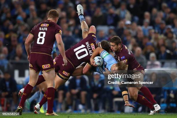 Jack De Belin of the Blues is tackled during game two of the State of Origin series between the New South Wales Blues and the Queensland Maroons at...