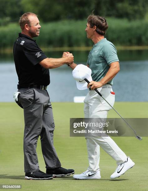 Justin Walters of South Africa congratulates Thorbjorn Olesen of Denmark on his round during day four of the BMW International Open at Golf Club Gut...