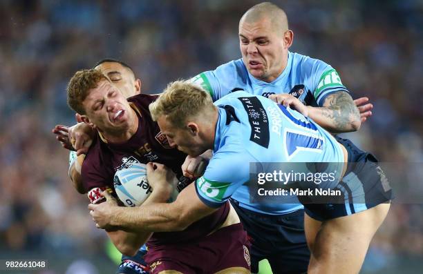 Dylan Napa of the Maroons is tackled during game two of the State of Origin series between the New South Wales Blues and the Queensland Maroons at...