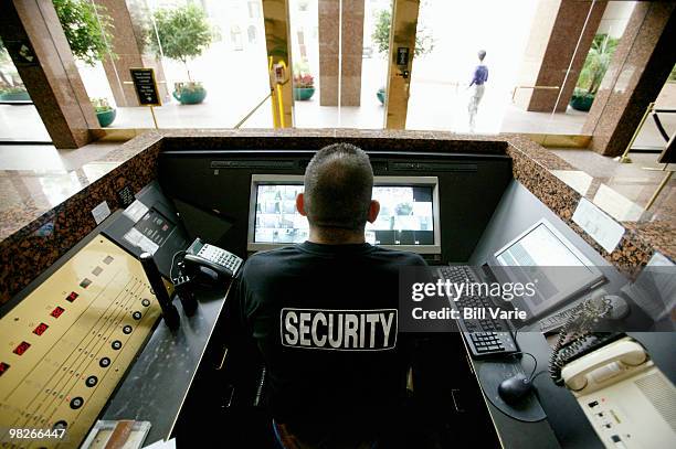 security officer at monitoring station - security guards stock-fotos und bilder