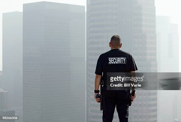 security officer on roof of building - security guard imagens e fotografias de stock