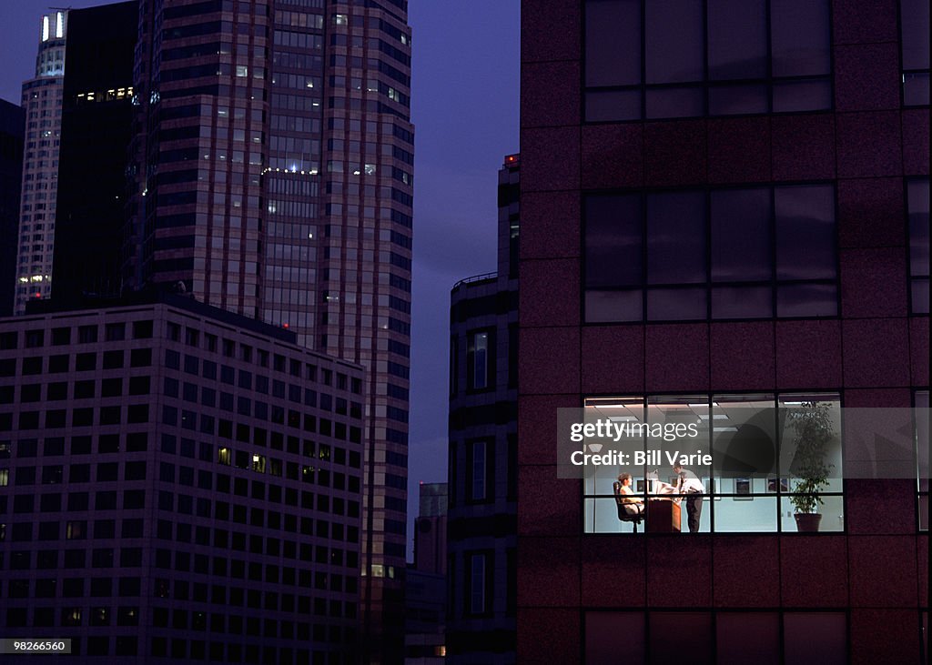 Businesspeople seen through skyscraper window