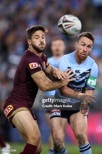 James Maloney of the Blues offloads the ball as Ben Hunt of the Maroons attempts to tackle during game two of the State of Origin series between the...