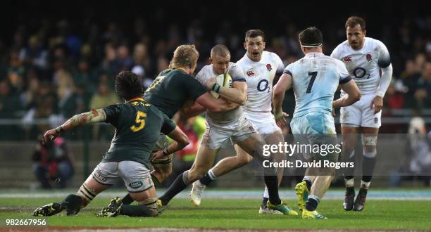 Mike Brown of England is tackled during the third test match between South Africa and England at Newlands Stadium on June 23, 2018 in Cape Town,...