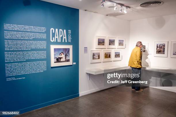 Man looking at the Robert Capa exhibit at Casa Nacional del Bicentenario.