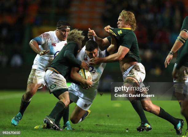 Ben Youngs of England is tackled by Pieter-Steph du Toit and Faf de Klerk during the third test match between South Africa and England at Newlands...