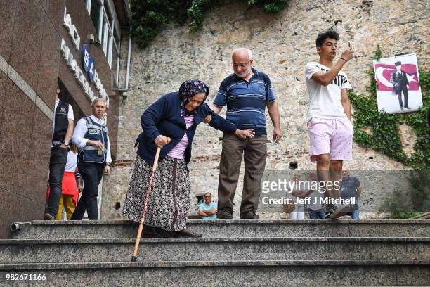 Residents of Istanbul depart Haci Sabanci polling station where he will cast his vote in the Turkish election on June 24, 2018 in Istanbul, Turkey....