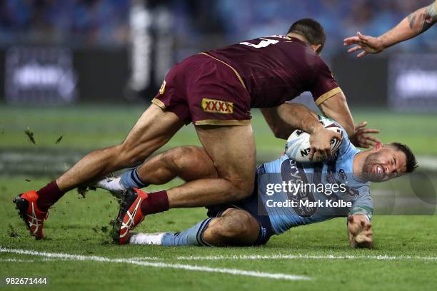 James Tedesco of the Blues is tackled by Greg Inglis of the Maroons during game two of the State of Origin series between the New South Wales Blues...