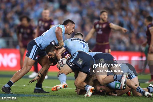 Greg Inglis of the Maroons is tackled during game two of the State of Origin series between the New South Wales Blues and the Queensland Maroons at...