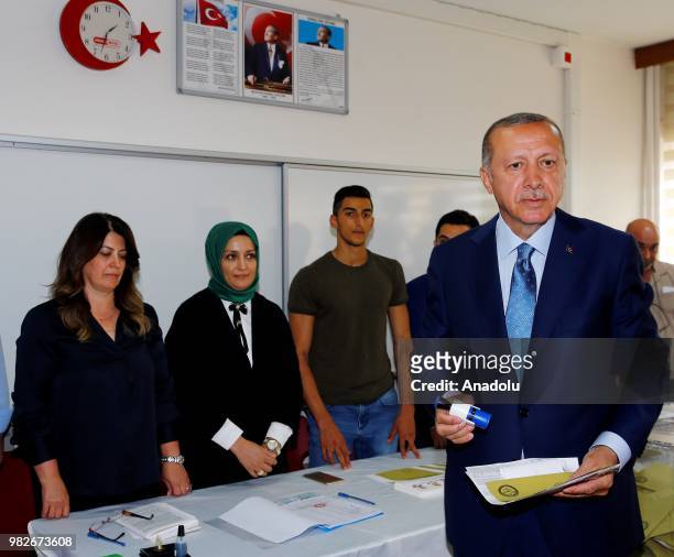 Turkish President Recep Tayyip Erdogan casts his vote at a polling station during the parliamentary and presidential elections, at Uskudar district...