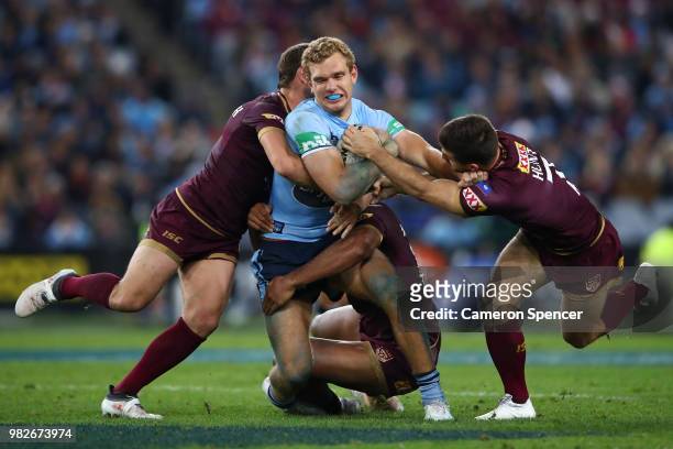 Tom Trbojevic of the Blues is tackled during game two of the State of Origin series between the New South Wales Blues and the Queensland Maroons at...