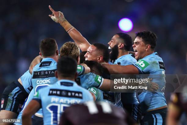 Tyson Frizell, Josh Addo-Carr and Latrell Mitchell of the Blues and team mates celebrate victory at the end of game two of the State of Origin series...