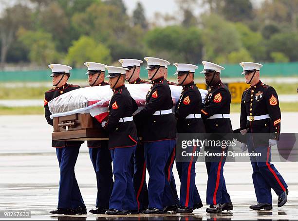 Marine honor guard carry the casket of LAPD SWAT officer and US Marine reservist Sgt. Maj. Robert J. Cottle, killed March 24 in a roadside bombing in...