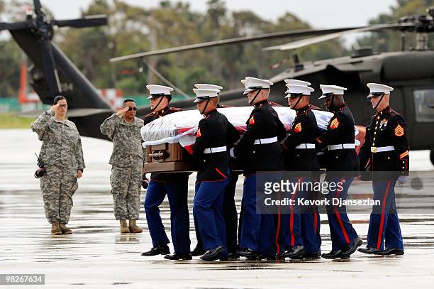 Marine honor guard carry the casket of LAPD SWAT officer and US Marine reservist Sgt. Maj. Robert J. Cottle, killed March 24 in a roadside bombing in...