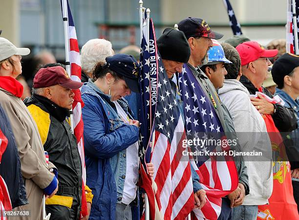 Members of the public line the tarmac with American flags to honor LAPD SWAT officer and US Marine reservist Sgt. Maj. Robert J. Cottle, killed March...