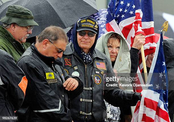 Members of the public line the tarmac with American flags to honor LAPD SWAT officer and US Marine reservist Sgt. Maj. Robert J. Cottle, killed March...