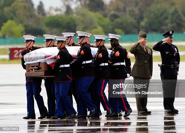 Marine honor guard carry the casket of LAPD SWAT officer and US Marine reservist Sgt. Maj. Robert J. Cottle, killed March 24 in a roadside bombing in...