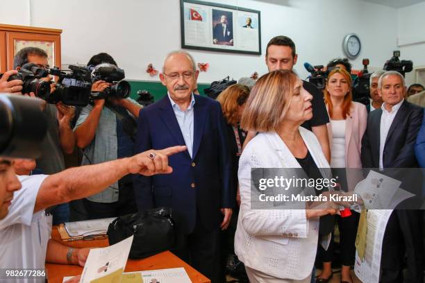 Turkey's main opposition Republican People's Party Kemal Kilicdaroglu and his wife Selvi Kilicdaroglu casts their ballot at a polling station during...
