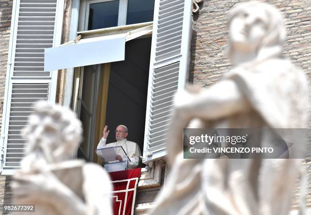 Pope Francis blesses after delivering his message to pilgrims gathered at Saint Peter's square, during his Angelus Sunday prayer at the Vatican on...