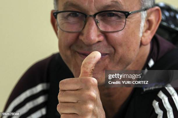 Mexico's coach Juan Carlos Osorio listens to goalkeeper Guillermo Ochoa speaking at a press conference ahead of a training session at the Novogorsk...