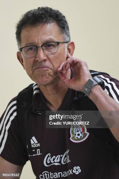 Mexico's coach Juan Carlos Osorio listens to goalkeeper Guillermo Ochoa speaking at a press conference ahead of a training session at the Novogorsk...