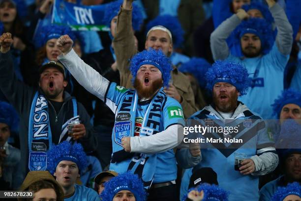 Blues fans celebrate during game two of the State of Origin series between the New South Wales Blues and the Queensland Maroons at ANZ Stadium on...