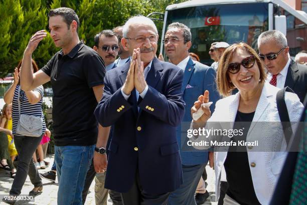 Turkey's main opposition Republican People's Party Kemal Kilicdaroglu , his wife Selvi and his son Kerem gestures after casting his vote at a polling...