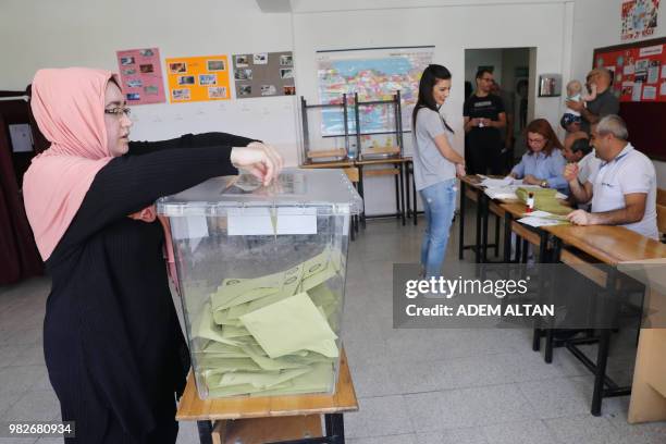 Woman casts her ballot at a polling station during snap twin Turkish presidential and parliamentary elections in Ankara on June 24, 2018. - Turks...