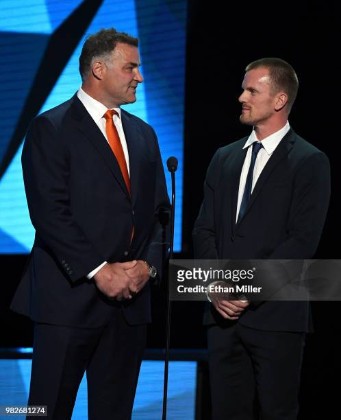Hockey Hall of Fame member Eric Lindros and Daniel Sedin of the Vancouver Canucks present an award during the 2018 NHL Awards presented by Hulu at...