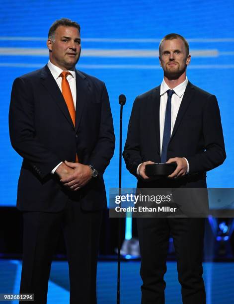 Hockey Hall of Fame member Eric Lindros and Daniel Sedin of the Vancouver Canucks present an award during the 2018 NHL Awards presented by Hulu at...